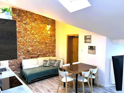 a living room with a couch and a table at Old Town Apt -Bosacka 2 bedrooms B43 in Kraków