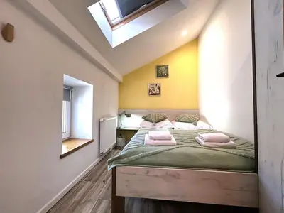 a bedroom with a bed with pink pillows on it at Old Town Apt -Bosacka 2 bedrooms B43 in Kraków