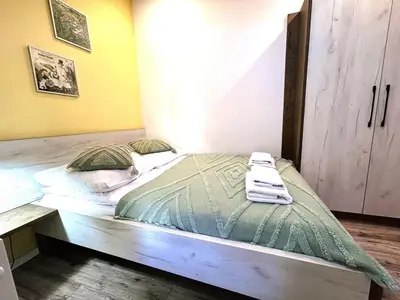 a bed with two towels on it in a room at Old Town Apt -Bosacka 2 bedrooms B43 in Kraków