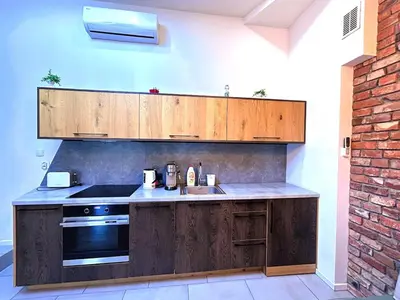 a kitchen with wooden cabinets and a sink and a stove at Old Town Apt -Bosacka 2 bedrooms B43 in Kraków