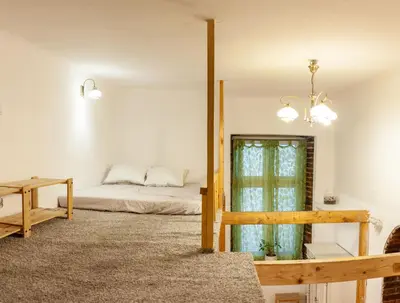 a bedroom with a bed and a table and a window at Apartment no5 Szlak street in Kraków