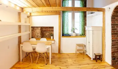 a dining room with a table and chairs and a fireplace at Apartment no5 Szlak street in Kraków