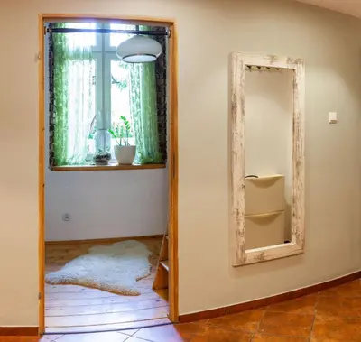 a mirror in a room with a window at Apartment no5 Szlak street in Kraków