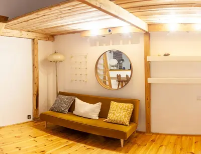 a living room with a couch and a mirror at Apartment no5 Szlak street in Kraków