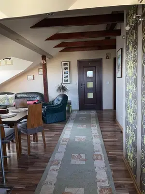 a living room with a table and chairs and a door at Noclegi Weronika in Czajowice
