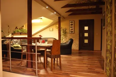 a living room with a table and a couch at Noclegi Weronika in Czajowice