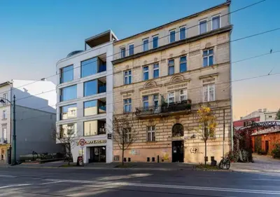 a large building on the corner of a street at Main Square Heaven Apartment in Kraków
