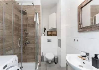 a bathroom with a shower and a toilet and a sink at Main Square Heaven Apartment in Kraków