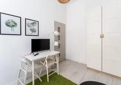 a white desk with a computer on it in a room at Main Square Heaven Apartment in Kraków