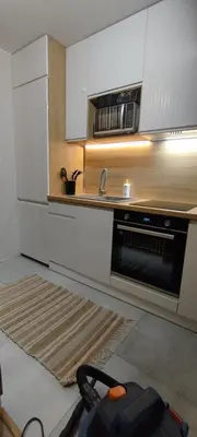 a kitchen with a sink and a stove at SmartApart in Kraków