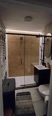 a bathroom with a shower and a toilet and a sink at SmartApart in Kraków