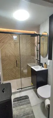 a bathroom with a shower and a toilet and a sink at SmartApart in Kraków