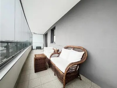 a balcony with two wicker chairs and a window at Apartment in cozy area for 4 guest, Cracow in Kraków