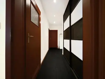 a hallway with wooden doors and a hallwayngth at Apartment in cozy area for 4 guest, Cracow in Kraków
