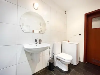 a white bathroom with a toilet and a sink at Apartment in cozy area for 4 guest, Cracow in Kraków