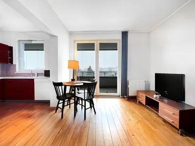 a living room with a table and chairs and a television at Apartment in cozy area for 4 guest, Cracow in Kraków