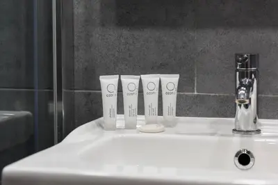 a bathroom sink with three toothbrushes at Underground Apartments by BookingHost in Kraków