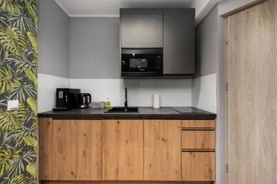 a kitchen with a sink and a microwave at Underground Apartments by BookingHost in Kraków