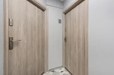 a pair of wooden doors in a room at Underground Apartments by BookingHost in Kraków