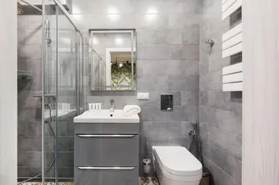 a bathroom with a toilet and a sink and a mirror at Underground Apartments by BookingHost in Kraków