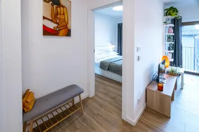 a living room with a couch and a bedroom at Balloon View Apartment in Kraków
