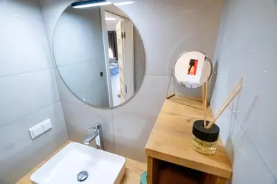 a bathroom with a sink and a mirror at Balloon View Apartment in Kraków