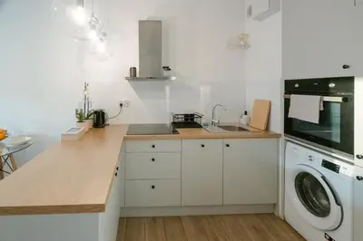 a kitchen with a sink and a washing machine at Balloon View Apartment in Kraków