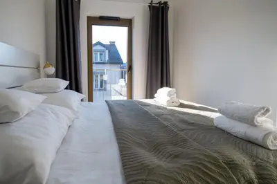 a bedroom with two beds with towels on them at Balloon View Apartment in Kraków