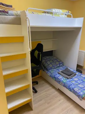 a bedroom with a bunk bed and a desk at Illumina nowoczesny apartament 50m2, spokojna okolica, 25min do centrum in Kraków