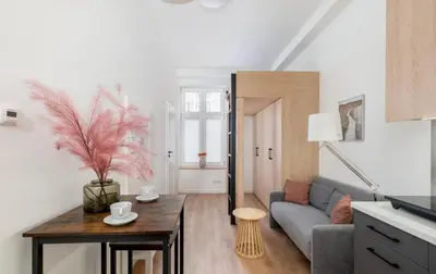 a living room with a couch and a table at Lumi Loft Kraków in Kraków