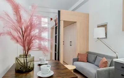 a living room with a couch and a table at Lumi Loft Kraków in Kraków