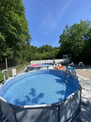 a large swimming pool with a table at Zaskawie Apart in Wadowice