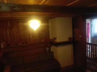 a light on the wall of a room with a bench at oBłędny Domek in Zawoja