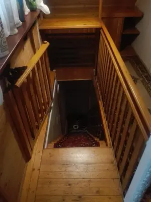 an empty staircase with a dog laying on the floor at oBłędny Domek in Zawoja