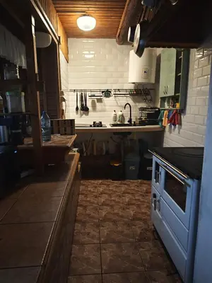 a kitchen with a sink and a stove top oven at oBłędny Domek in Zawoja