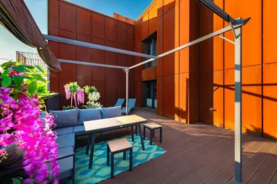 a patio with a table and chairs on a building at Apartment with private terrace by NEARTO PL in Kraków