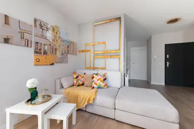 a living room with a couch and a table at Apartment with private terrace by NEARTO PL in Kraków