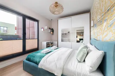 a bedroom with a large bed and a large window at Apartment with private terrace by NEARTO PL in Kraków