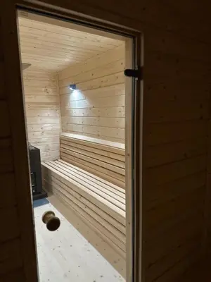 a sauna is shown through a door at Zielone Wzgórze- domki całoroczne Zawoja in Zawoja