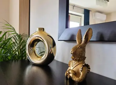 a table with a vase and a plate with a pumpkin at Apartament GOLD blisko Wawelu z DARMOWYM PARKINGIEM in Kraków