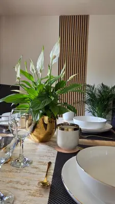 a dining room table with chairs and a television at Apartament GOLD blisko Wawelu z DARMOWYM PARKINGIEM in Kraków