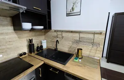 a kitchen with a sink and a counter top at Apartament GOLD blisko Wawelu z DARMOWYM PARKINGIEM in Kraków