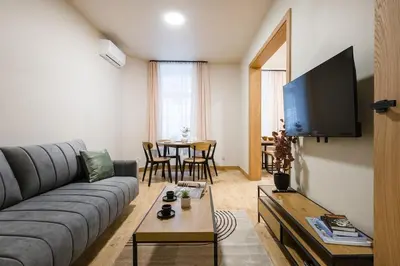 a kitchen and living room with a table and a microwave at D21 Cozy Apartment Old Town Kazimierz 50m2 in Kraków
