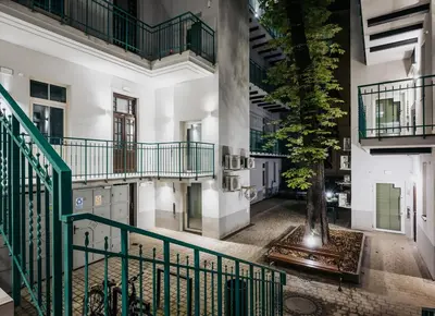 a kitchen with wooden cabinets and a table with bowls on it at D21 Cozy Apartment Old Town Kazimierz 50m2 in Kraków