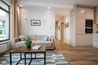 a living room with a couch and a table at InPoint Central Apartments in Kraków