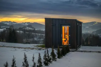 a small cabin in the snow in the mountains at Domki Gasiówka in Jaworzna