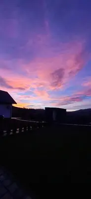 a view of a sunset from the backyard of a house at Domki Gasiówka in Jaworzna