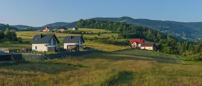 a group of houses on a hill in a field at Domki Gasiówka in Jaworzna
