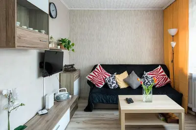 a living room with a couch and a table at Like home in Kraków