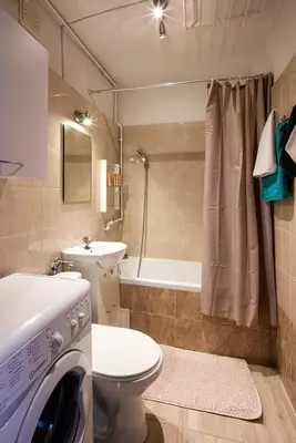 a bathroom with a toilet a sink and a washing machine at Like home in Kraków
